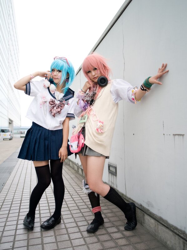 Cosplayers posing on a sidewalk