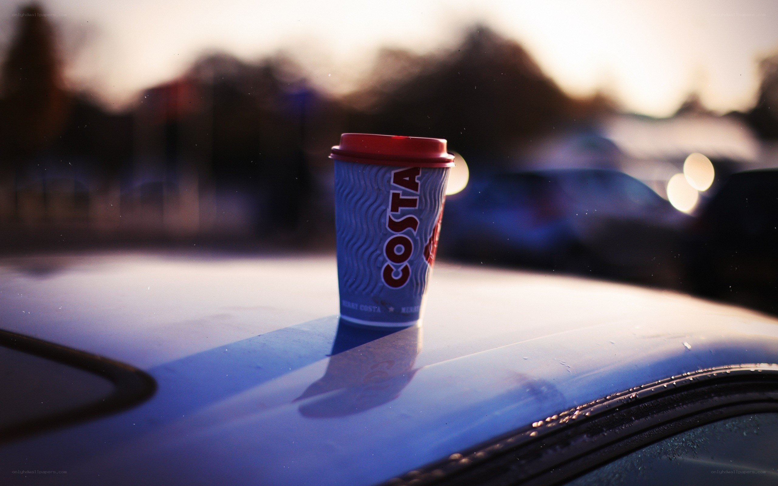 Costa coffee cup on car
