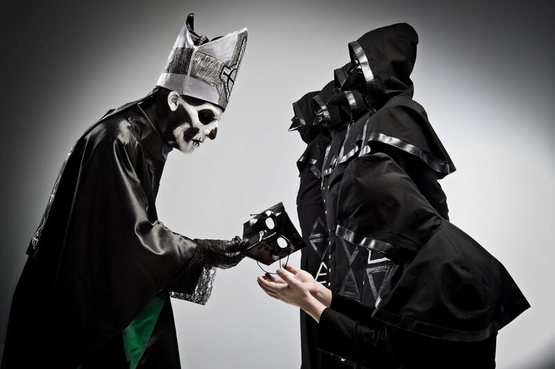 costumed figures exchanging mask