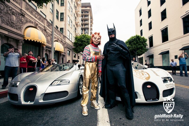 Costumed figures with luxury cars
