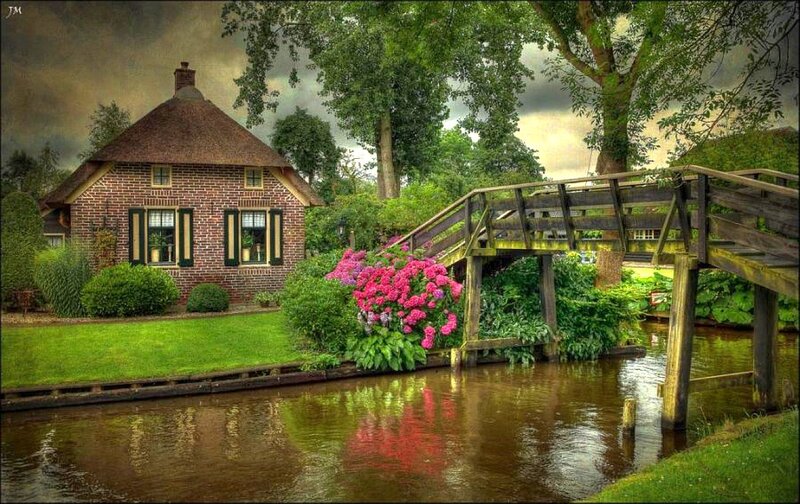 Cottage by a canal with bridge