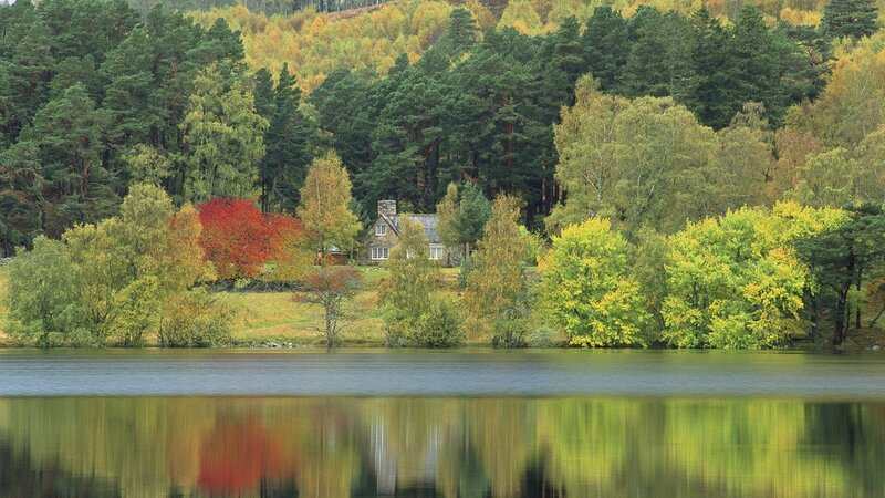 Cottage by a lake in autumn