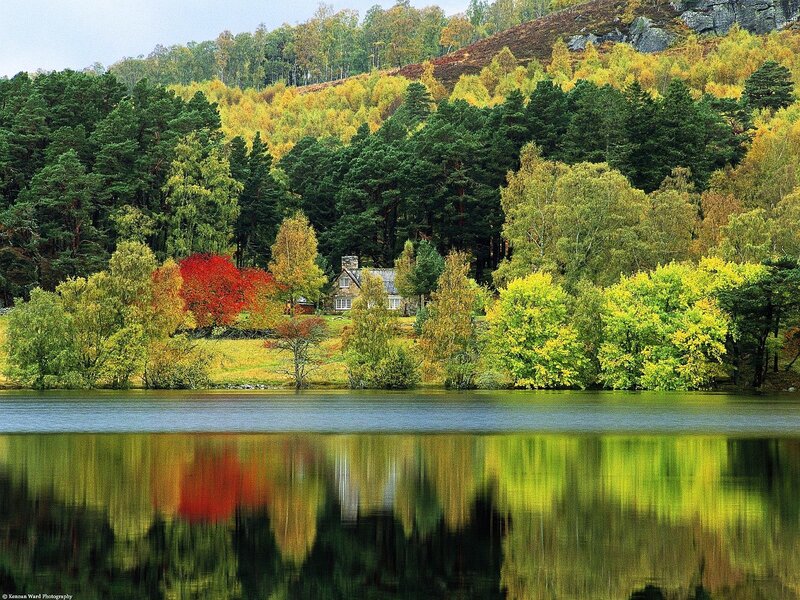Cottage by a lake in autumn