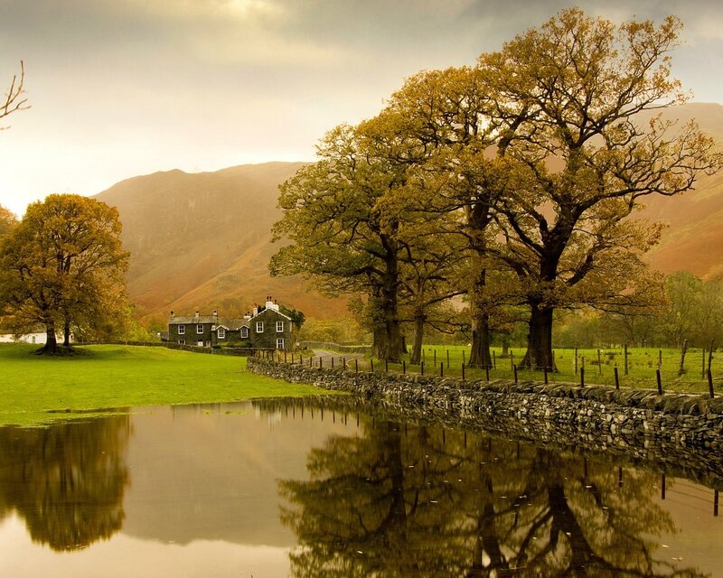 Cottage by a pond in the countryside