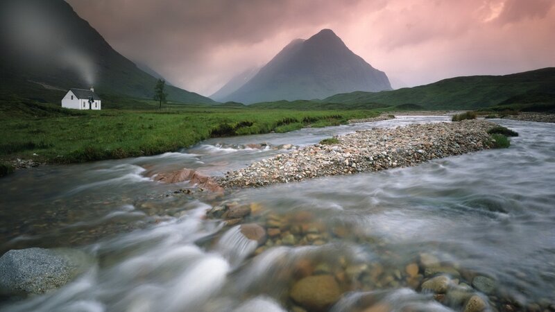 Cottage by a river in the Highlands