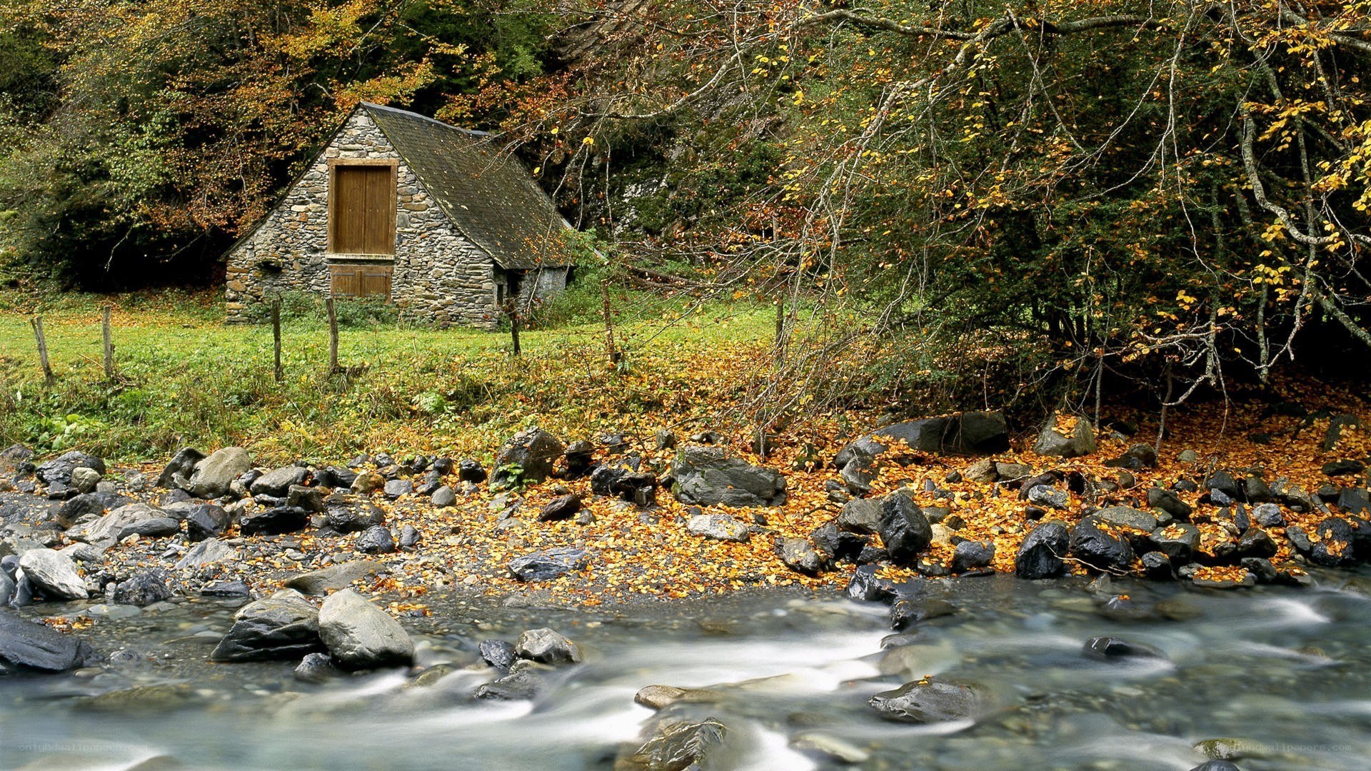 Cottage by a stream in autumn