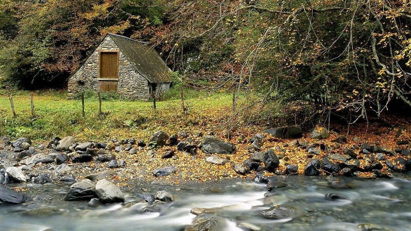 Cottage by a stream in autumn
