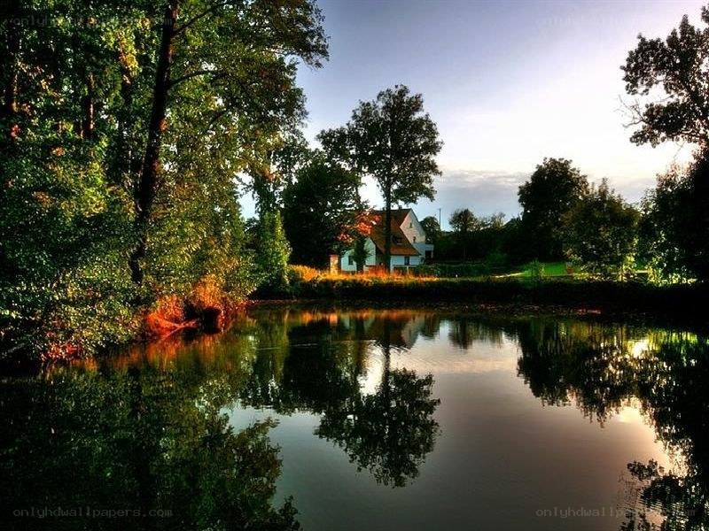 Cottage by the lake at sunset
