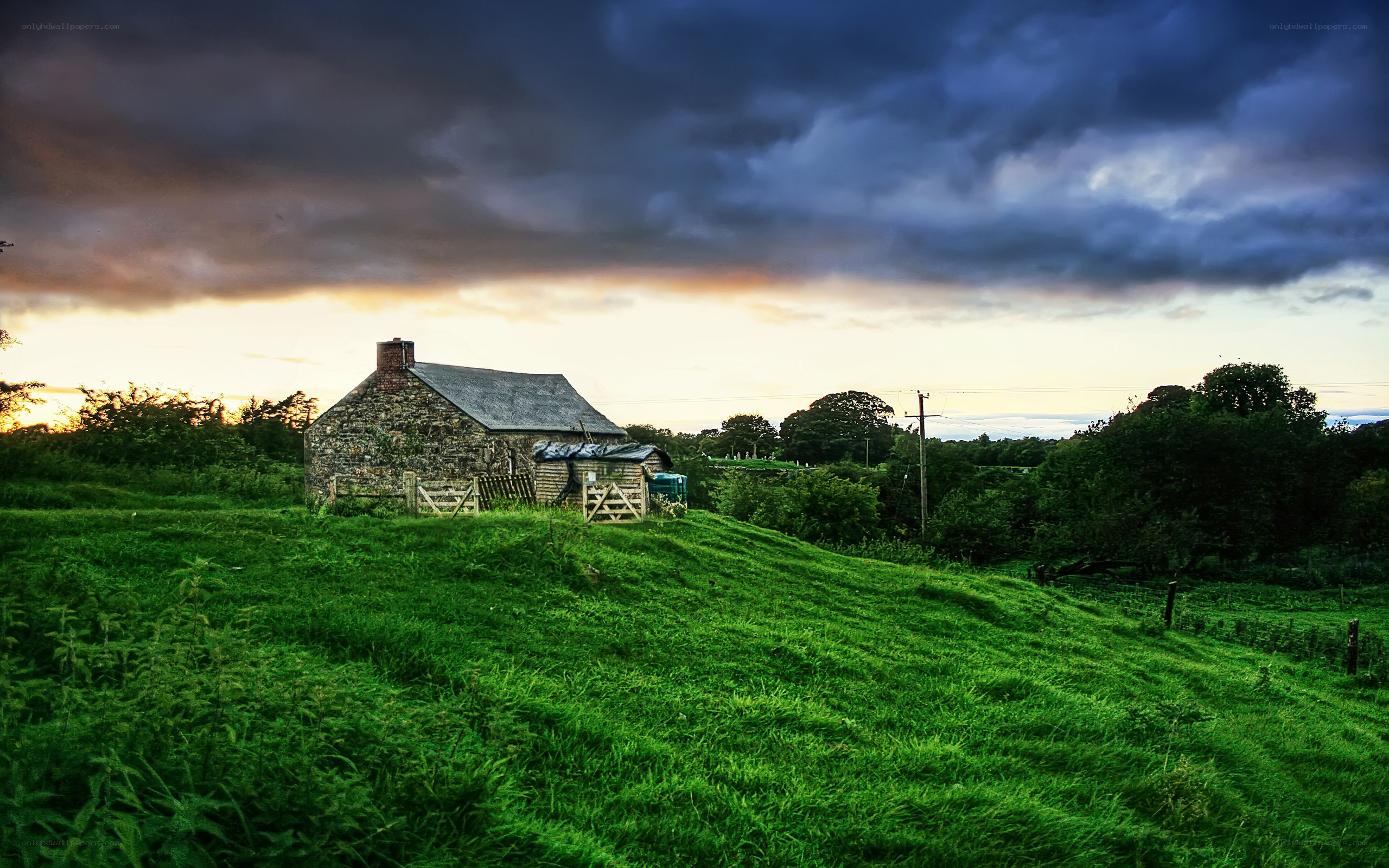 Cottage on a hill at sunset