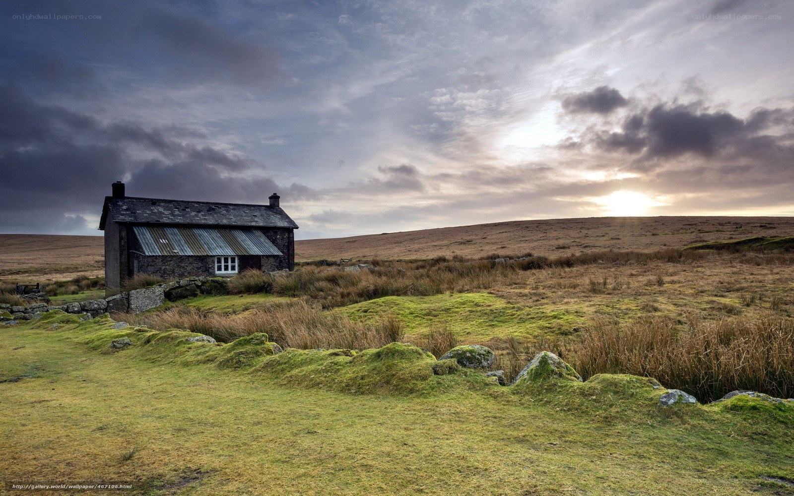 Cottage on a moor at sunset