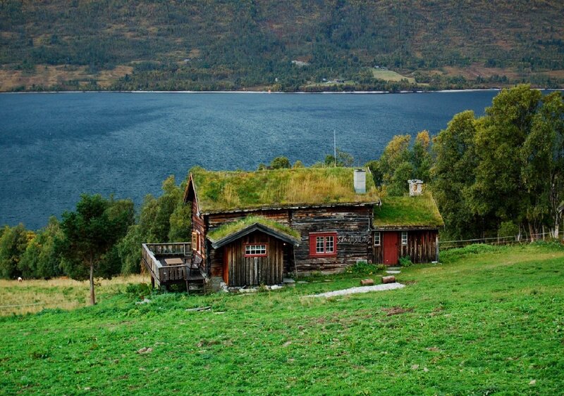 Cottage with grass roof by the lake