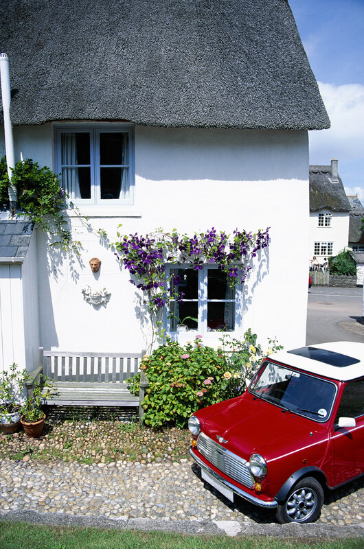 Cottage with red car