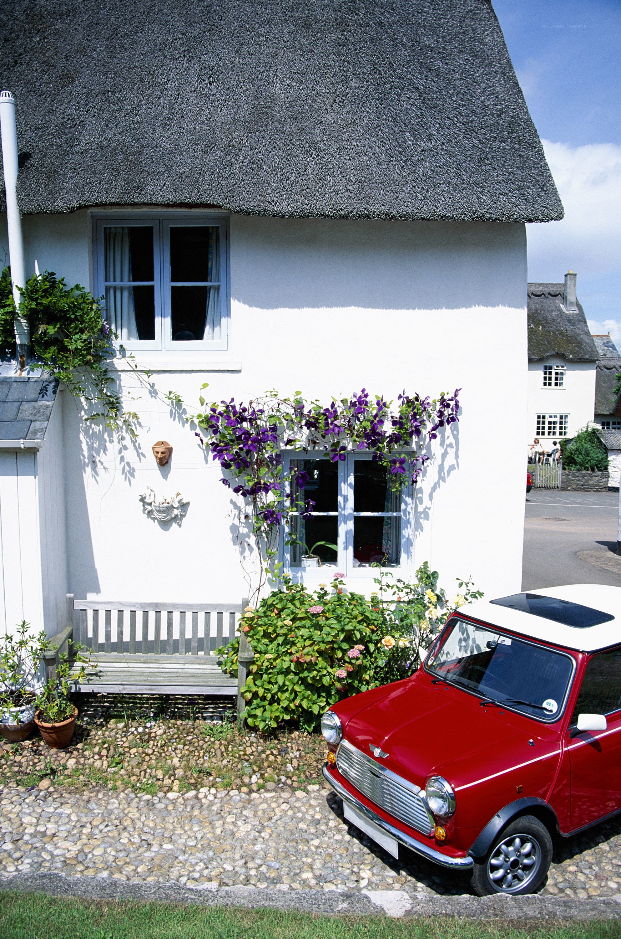 Cottage with red car