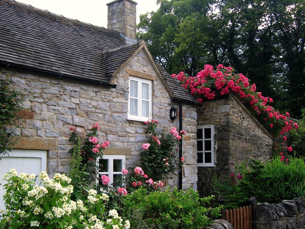Cottage with roses and stone walls