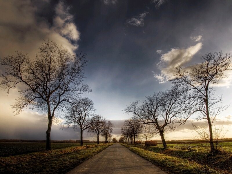 Country road under dramatic sky