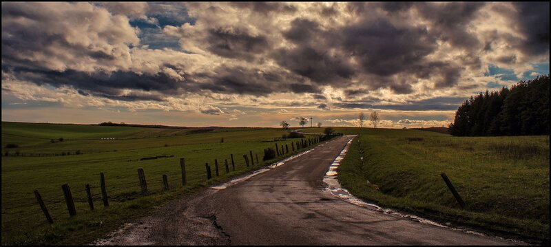 Country road under stormy sky