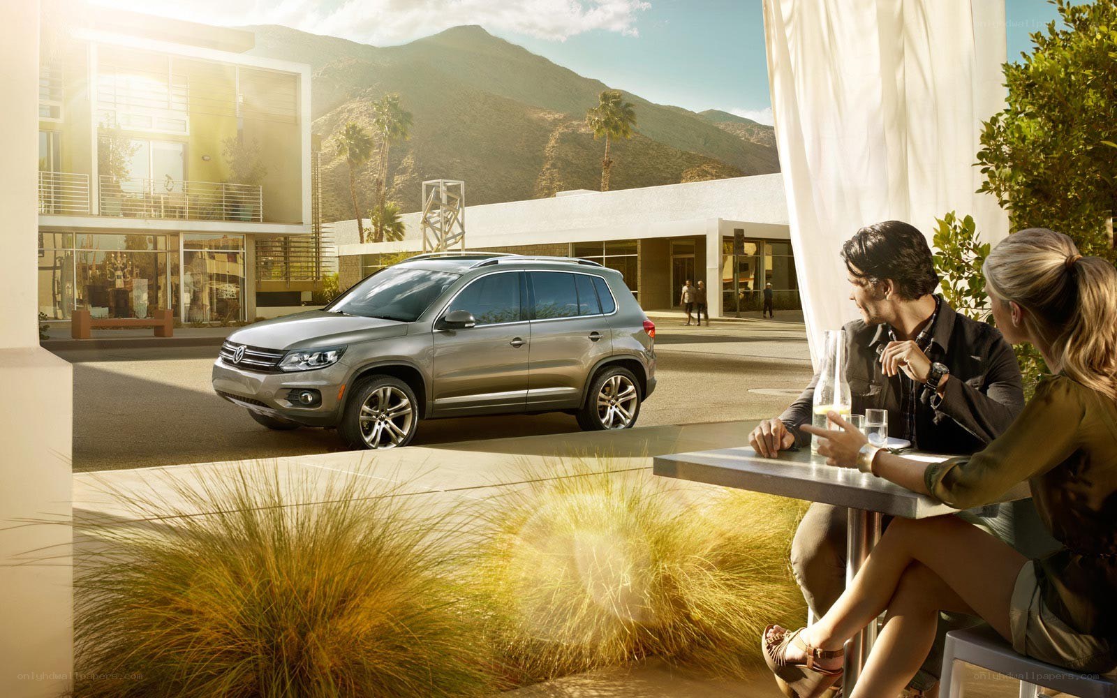 Couple at outdoor cafe with SUV