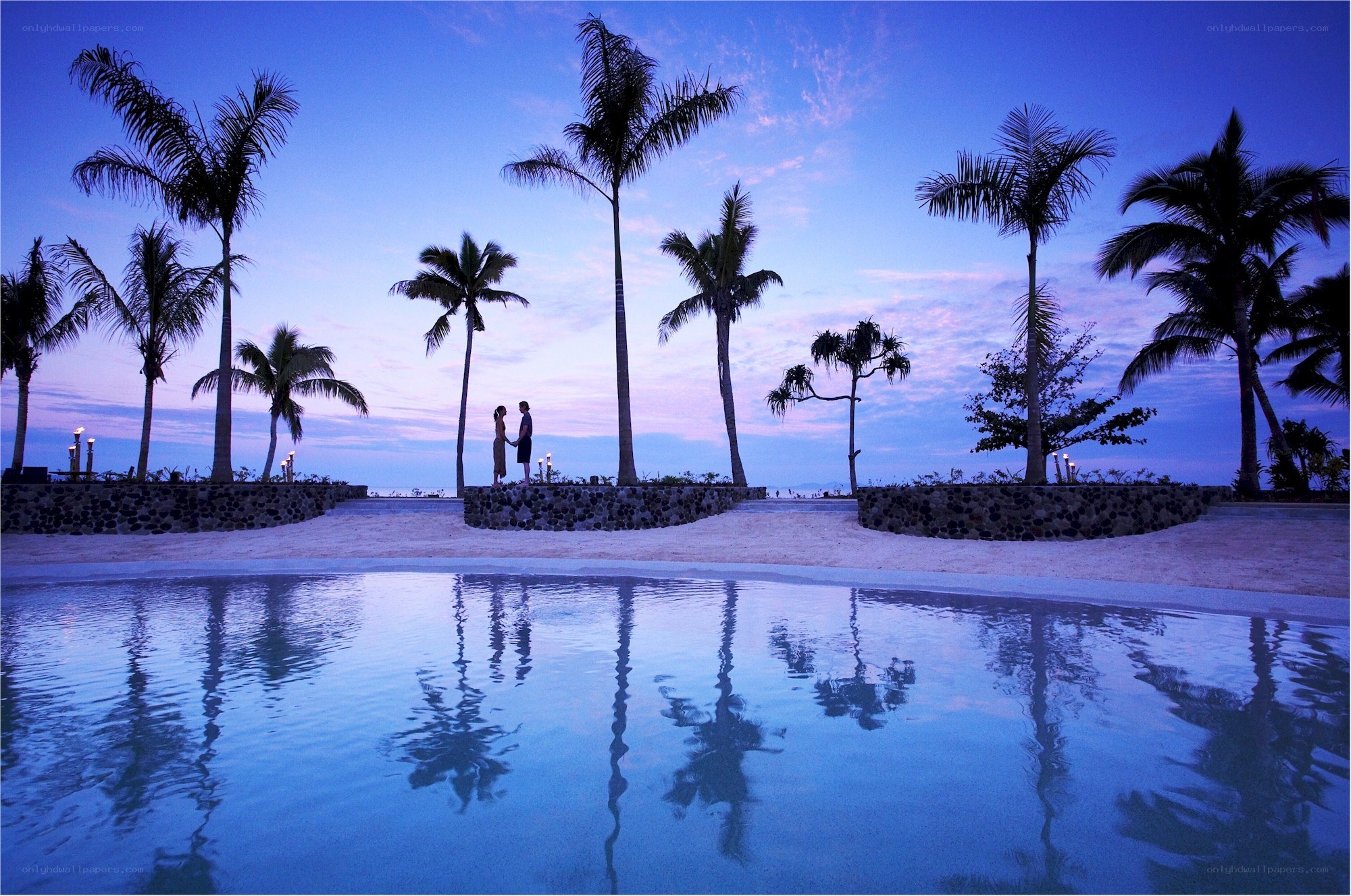 Couple at sunset by the pool
