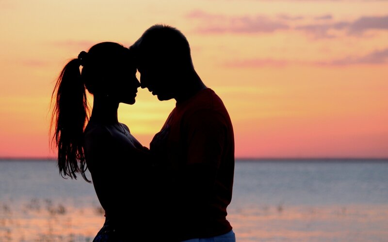 Couple at sunset by the water