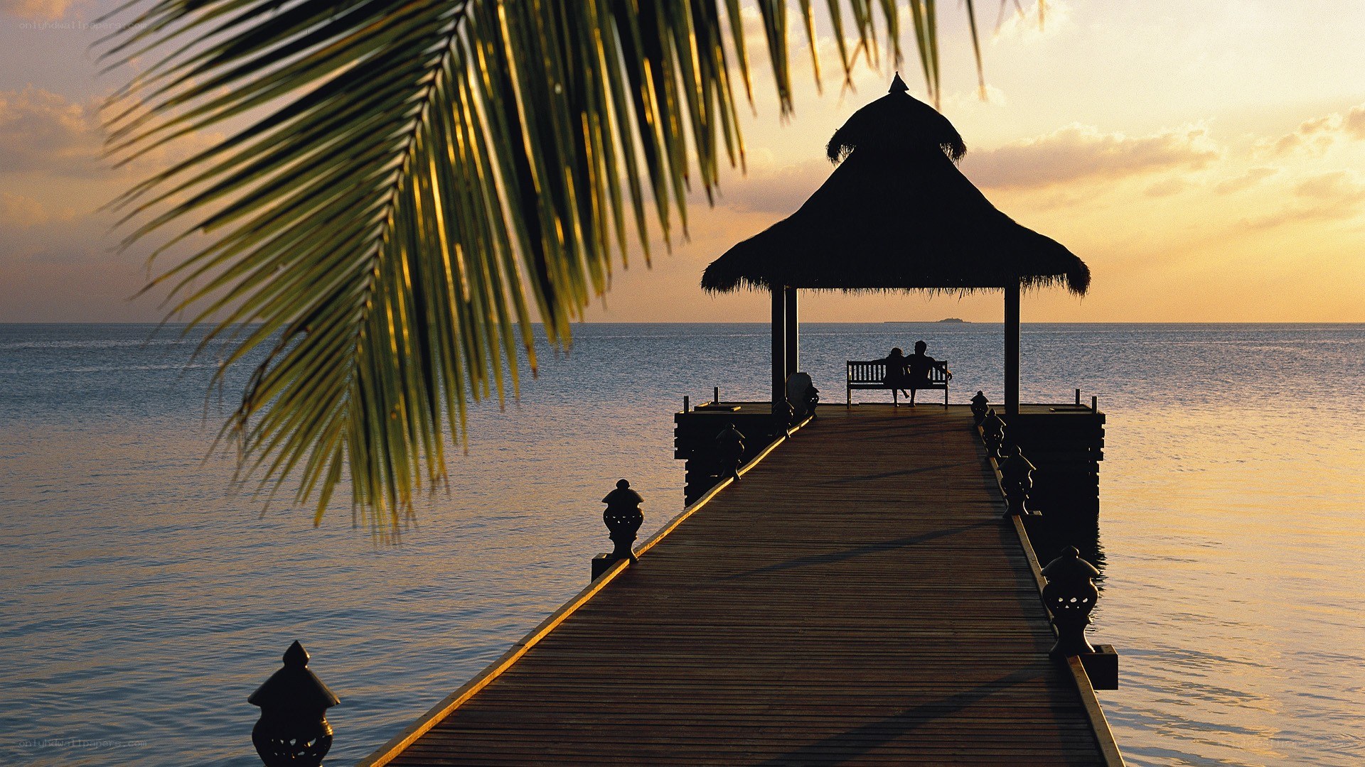 Couple at sunset on a pier