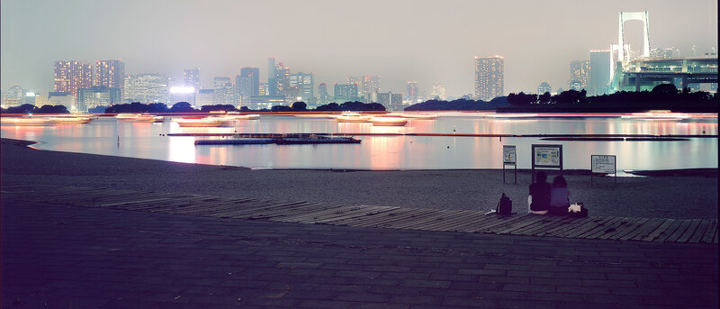 Couple at waterfront with city skyline