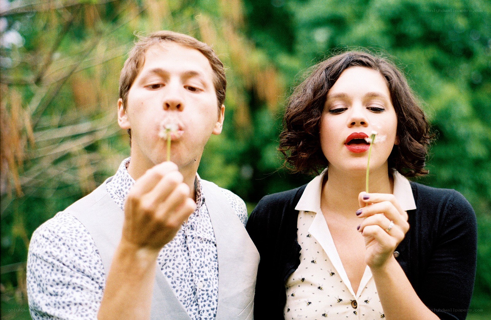 couple blowing dandelion seeds