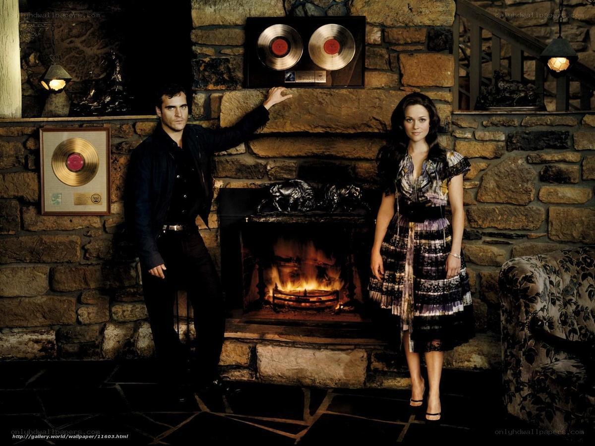 Couple by a fireplace with records