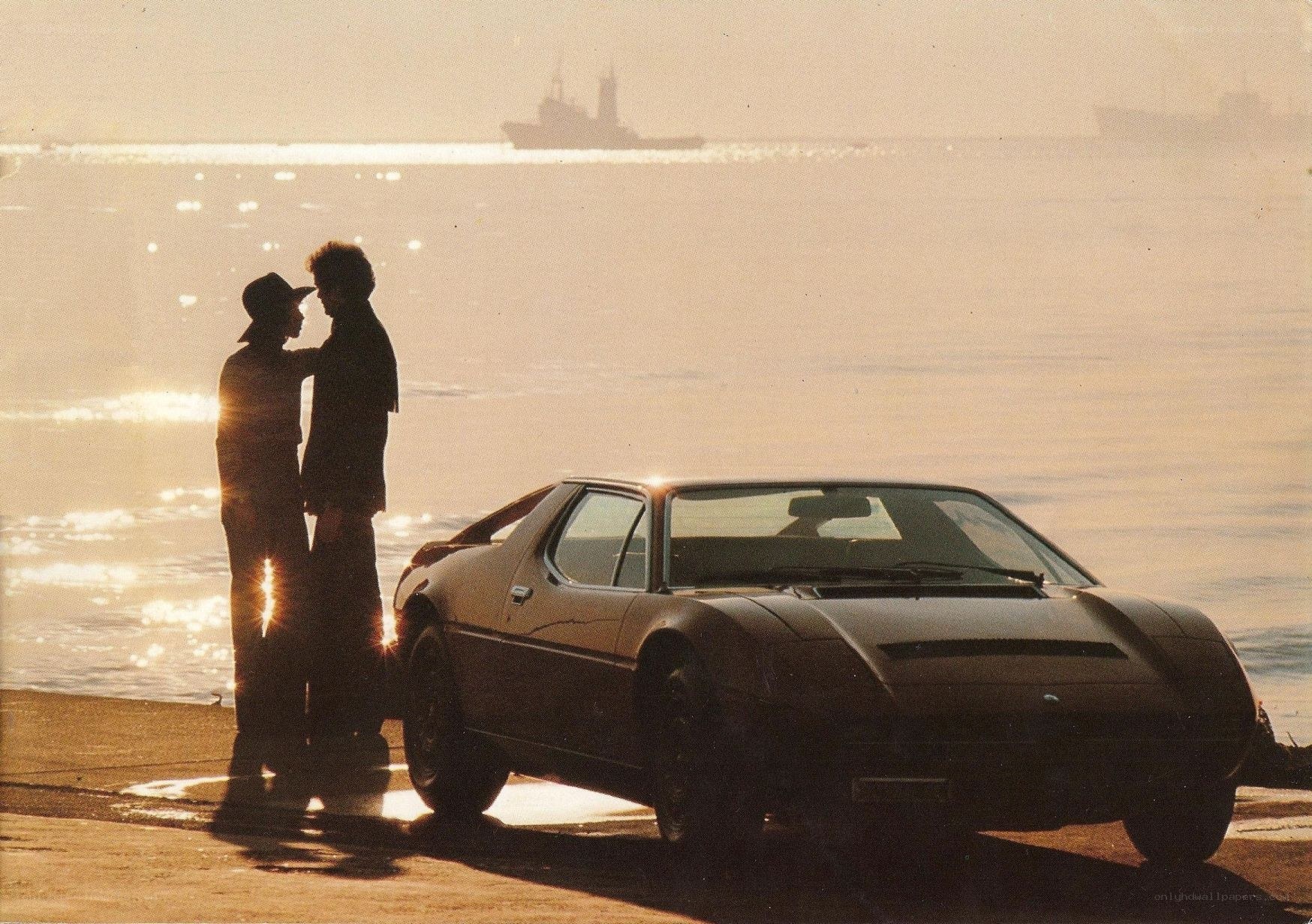 Couple by car at sunset