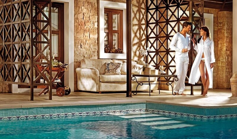Couple by poolside in white robes