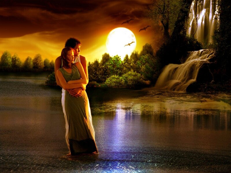 Couple by the waterfall at sunset
