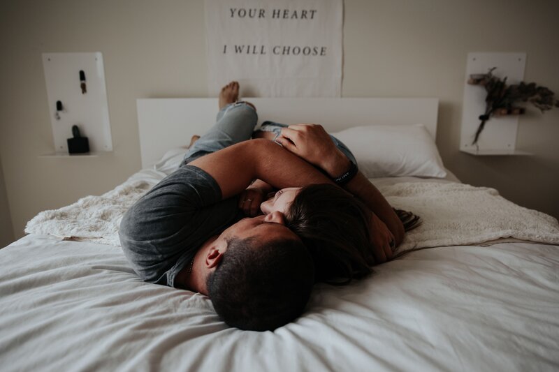 Couple cuddling on bed