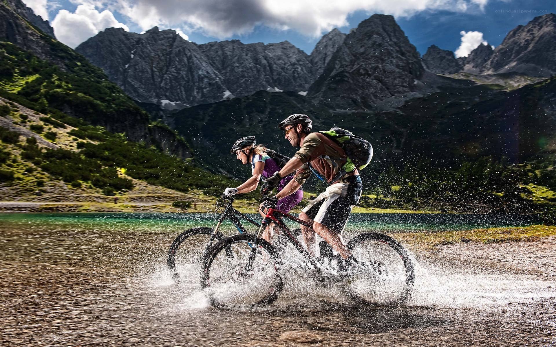 Couple cycling through water