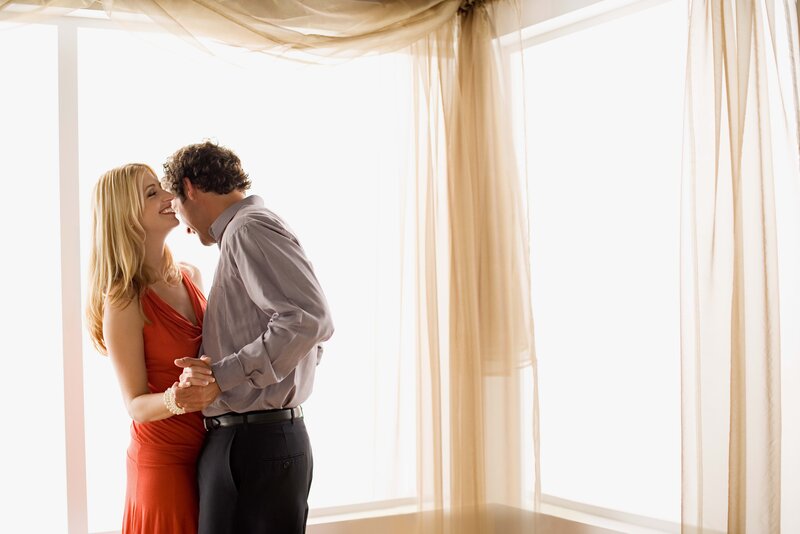 couple dancing by window