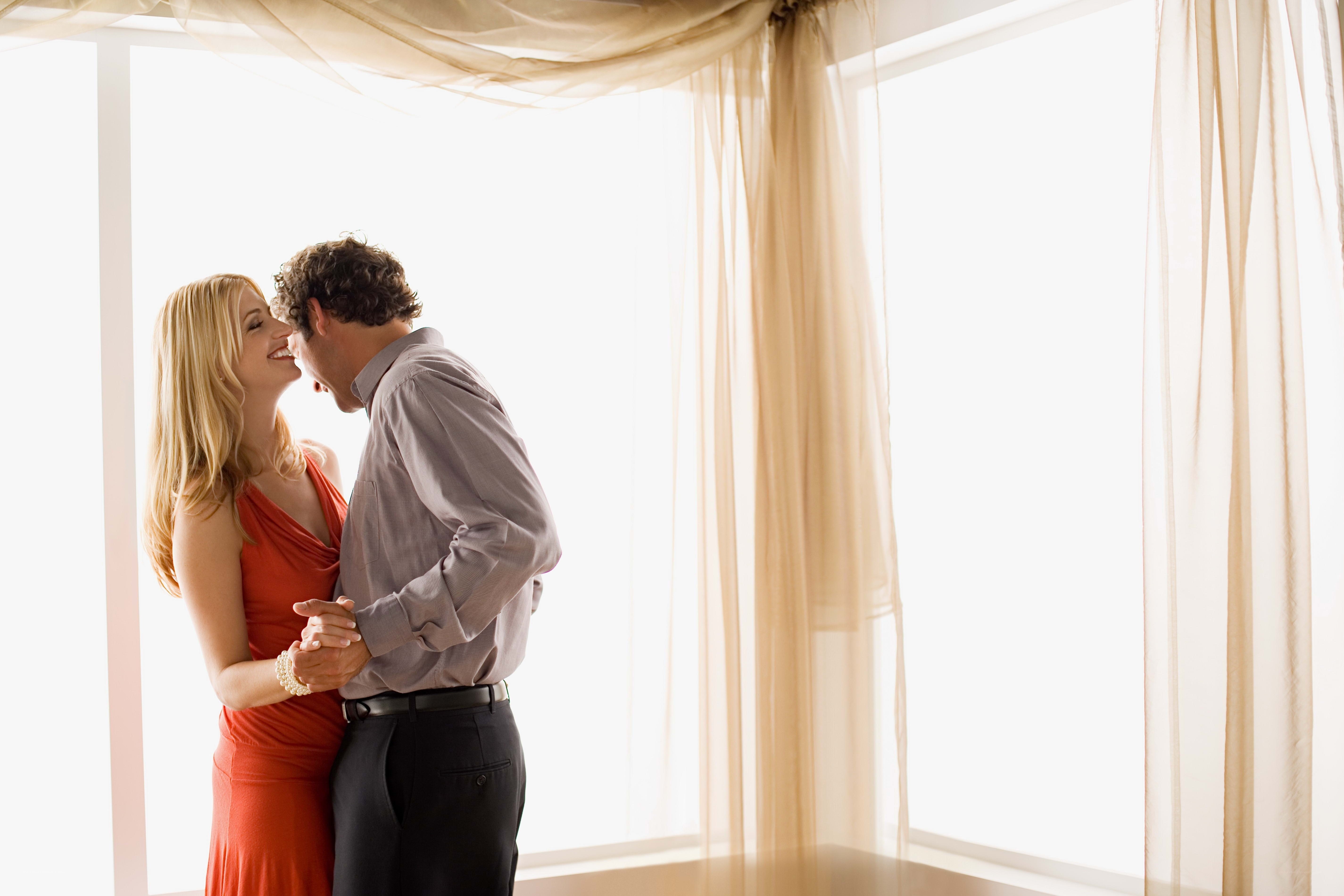 couple dancing by window