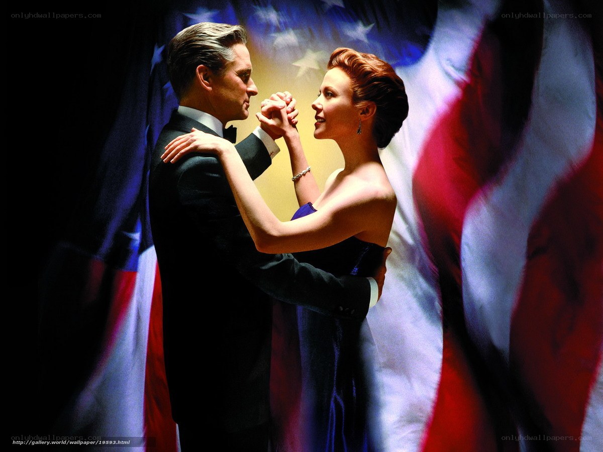 Couple dancing in front of flag