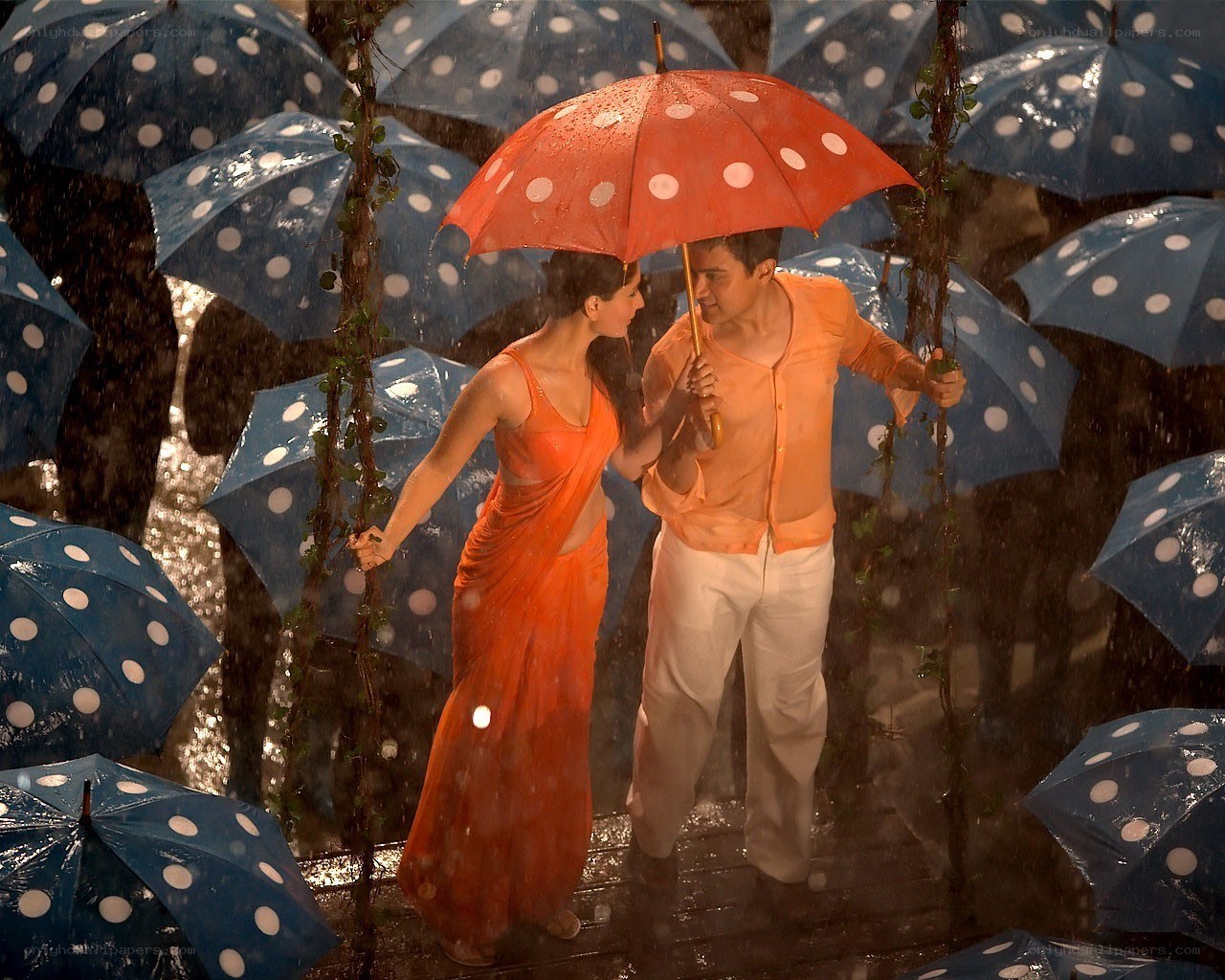 Couple dancing in rain with umbrellas