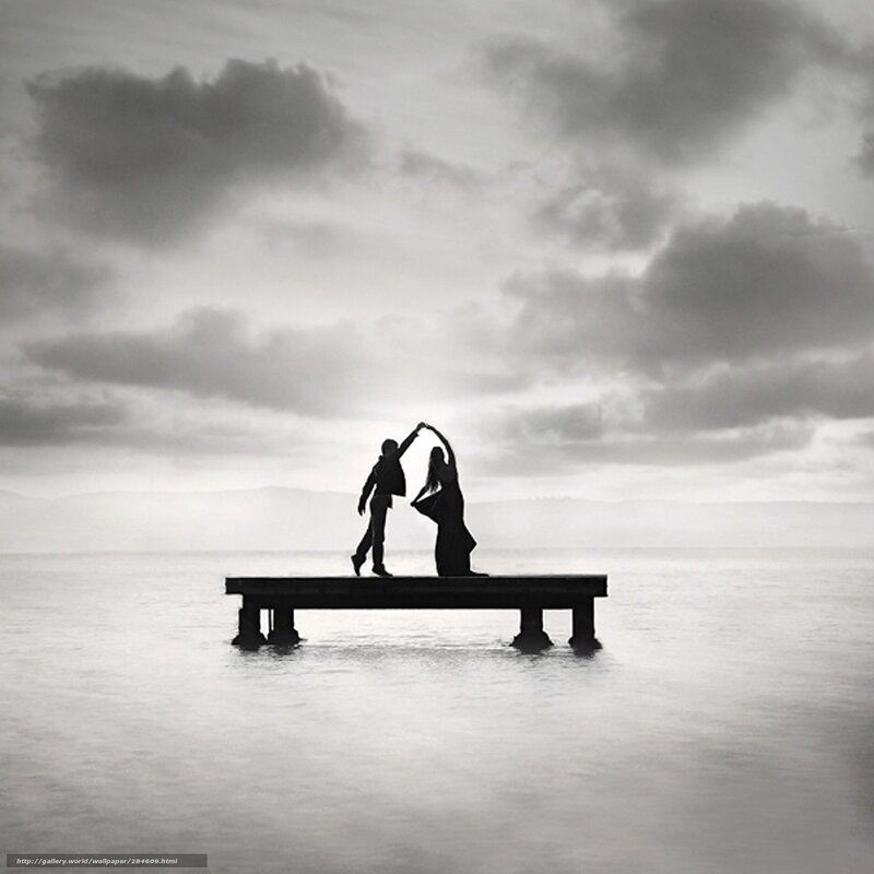 Couple dancing on a pier