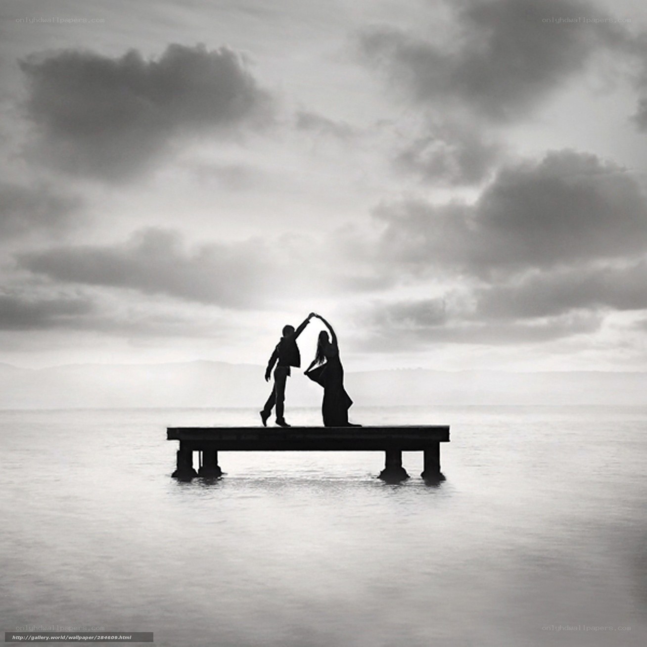 Couple dancing on a pier