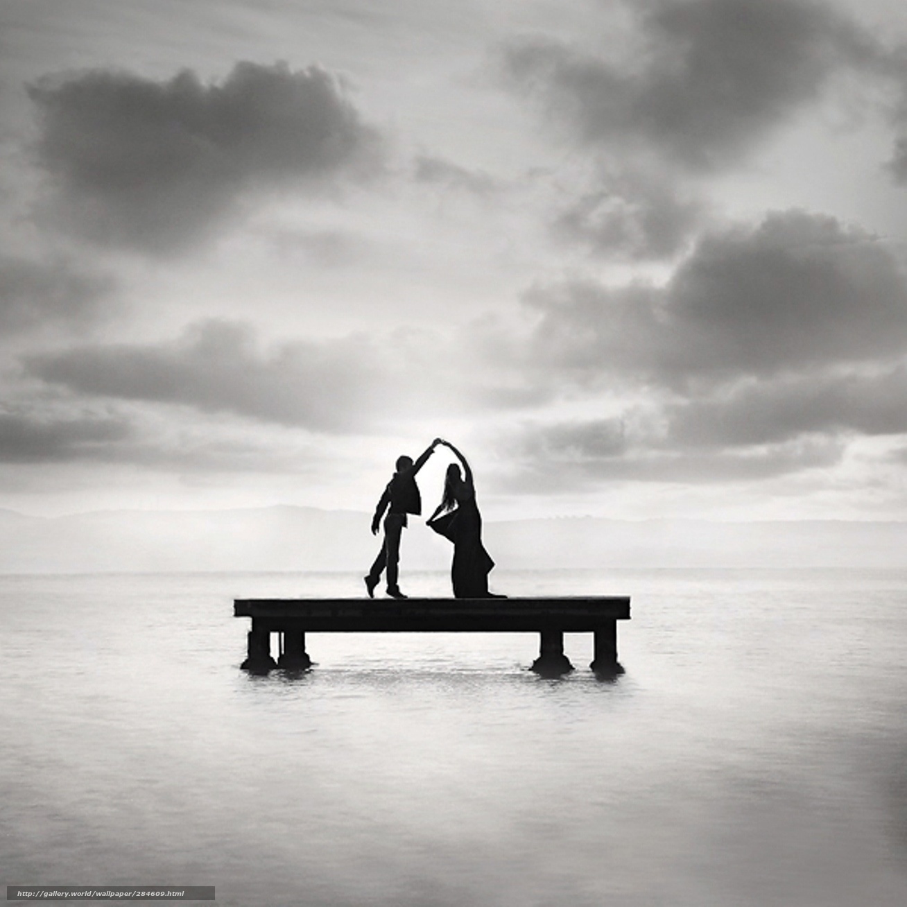 Couple dancing on a pier