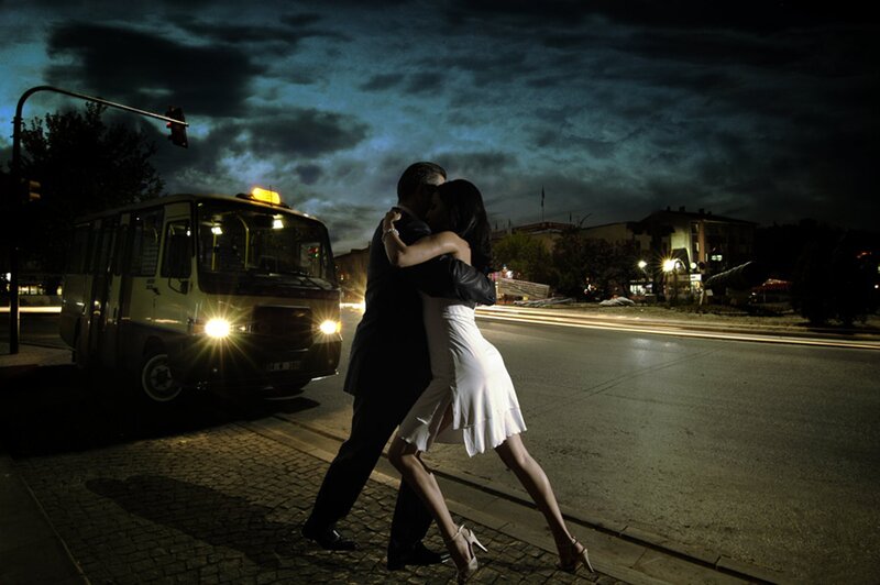 Couple dancing on street at night