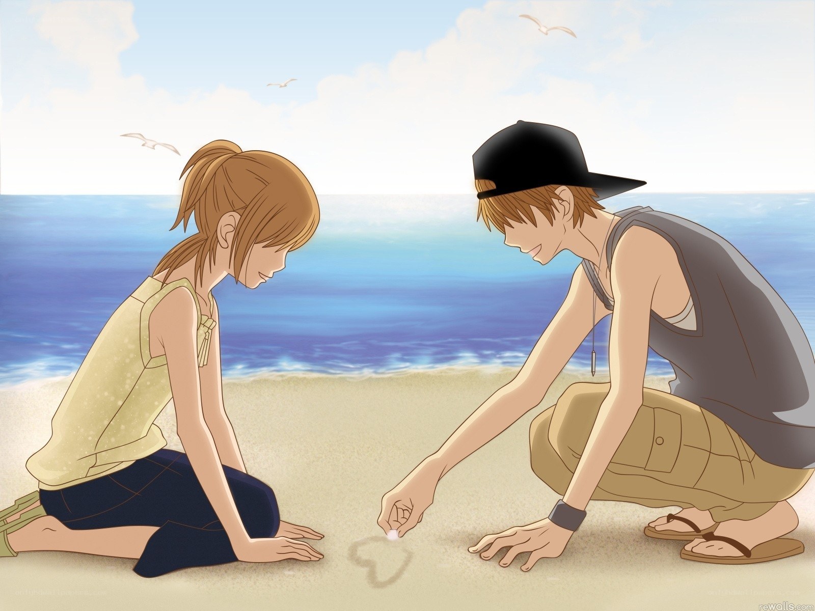couple drawing heart on beach