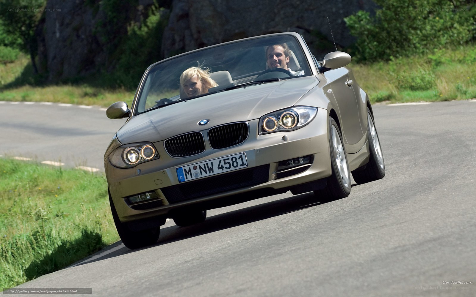 Couple driving convertible car