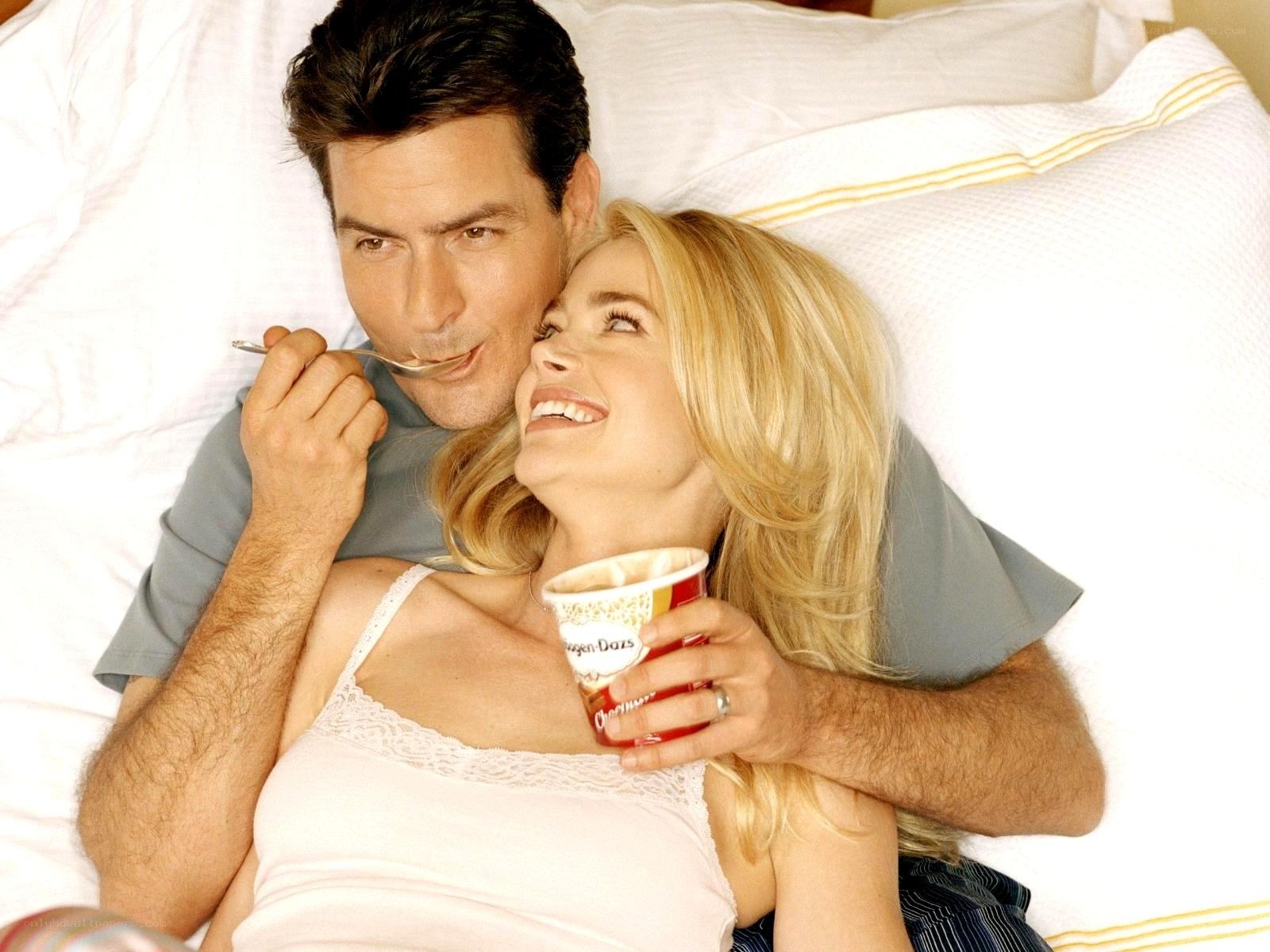 Couple eating ice cream in bed