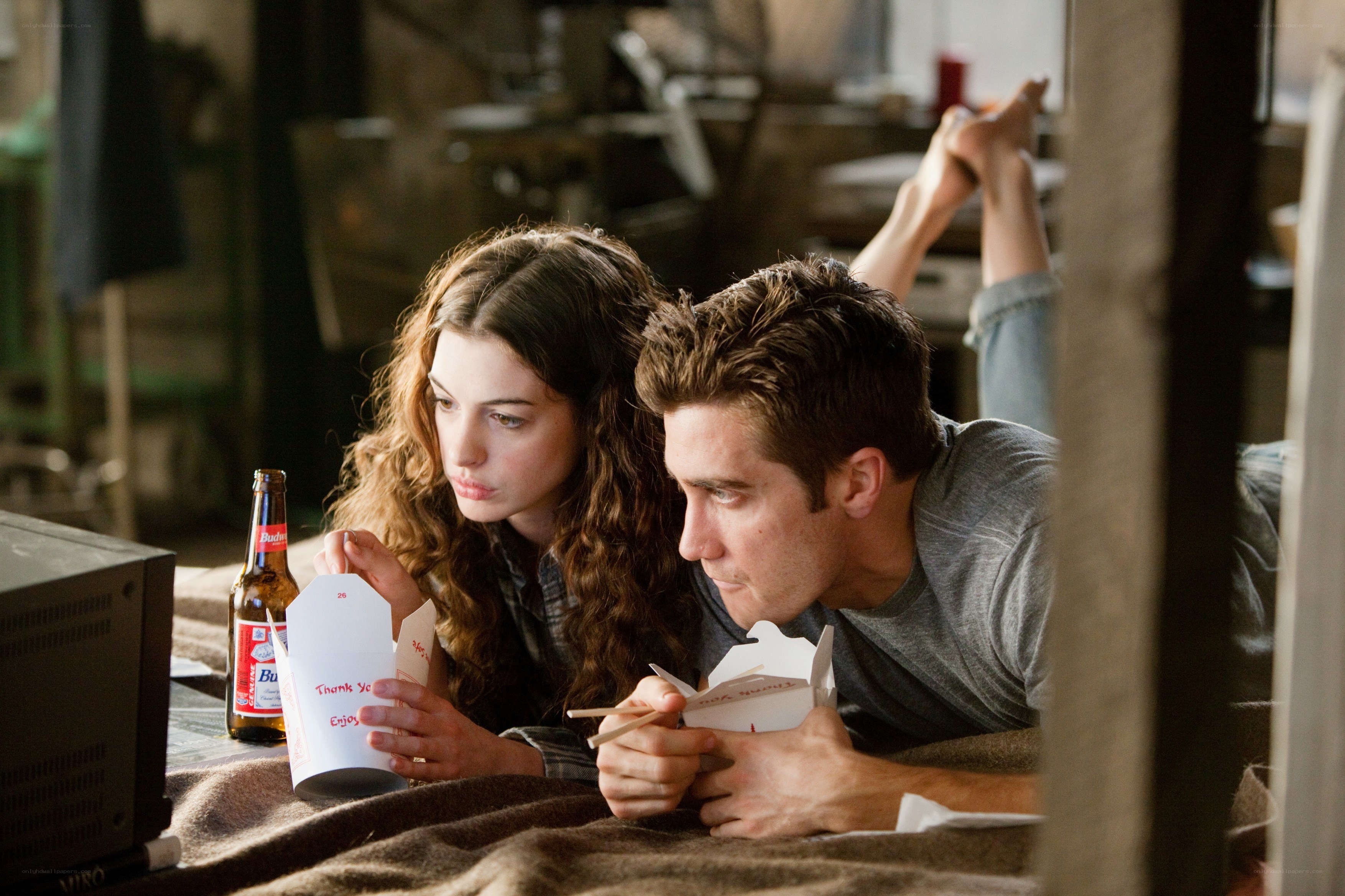 Couple eating takeout on bed