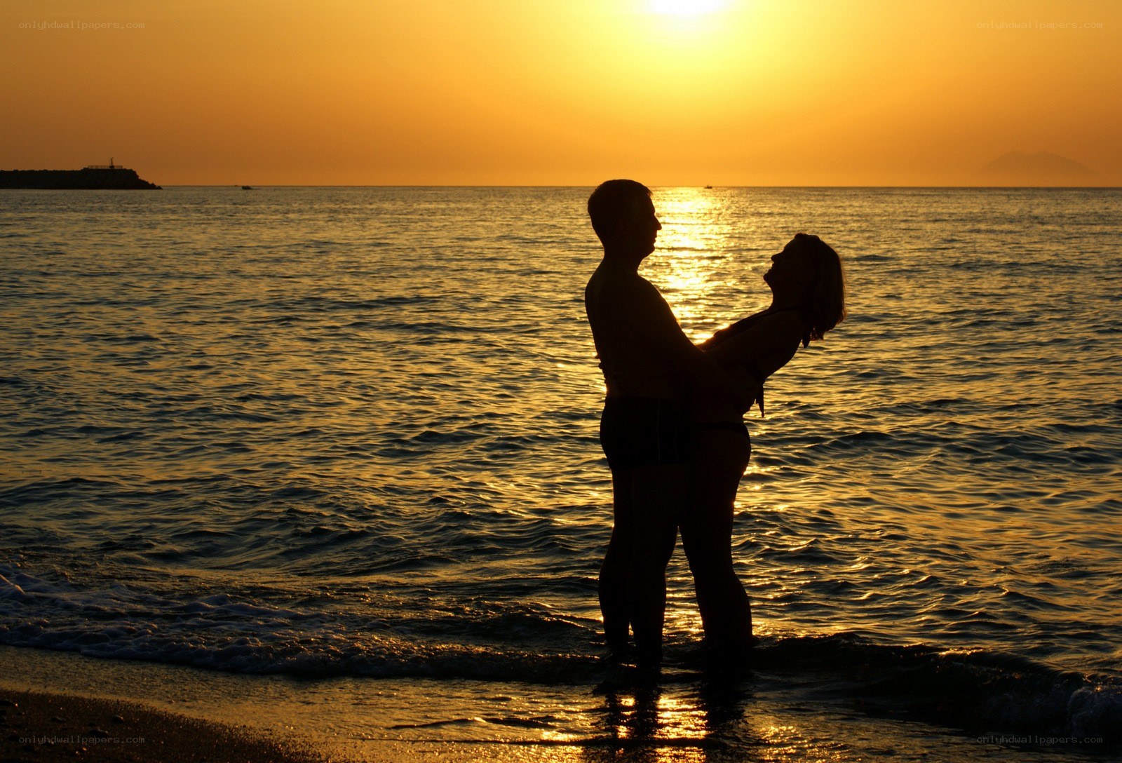 Couple embracing at sunset