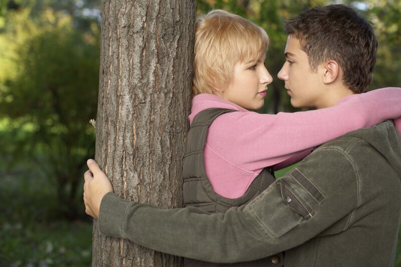 couple embracing by a tree