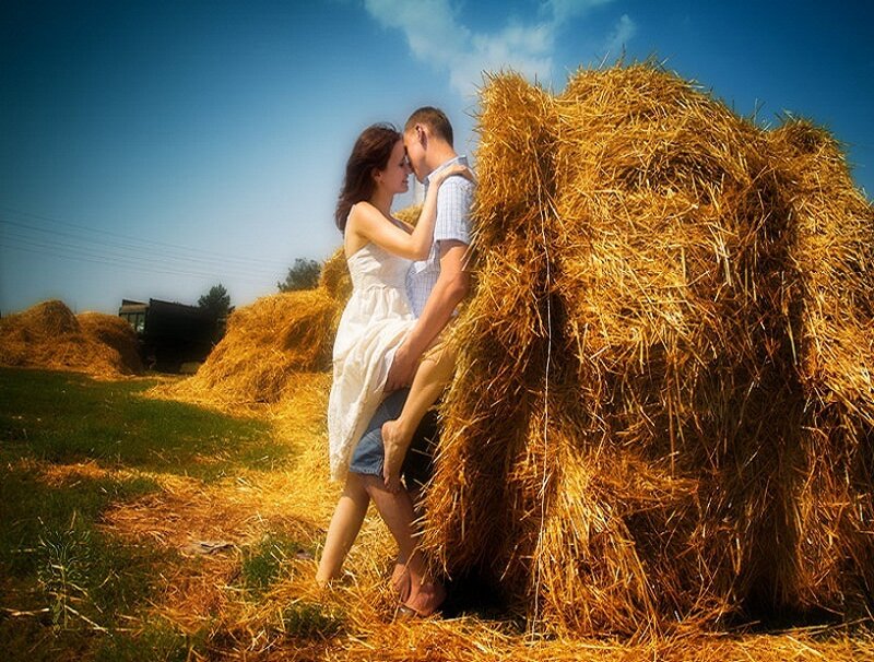 Couple Embracing by Hay Bale
