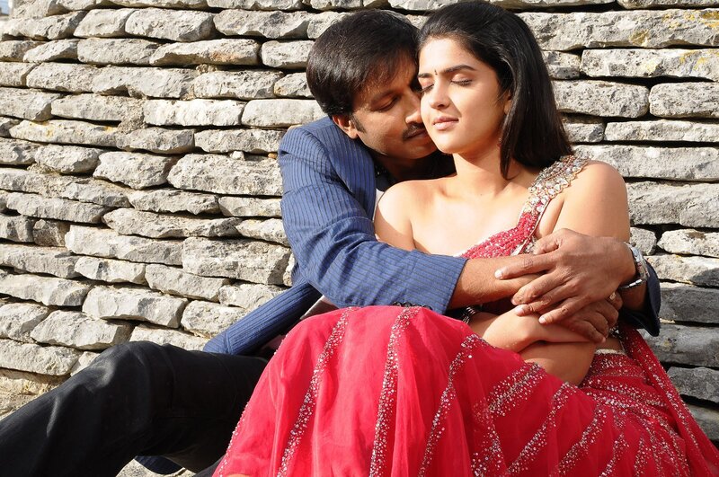 couple embracing by stone wall