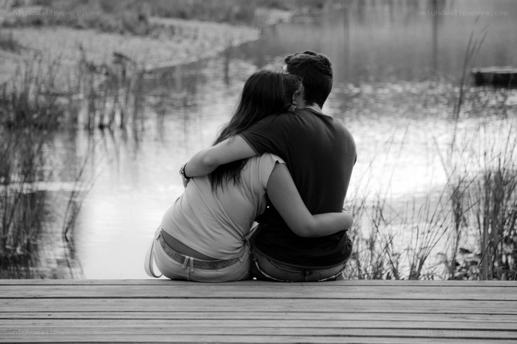 Couple embracing by the water
