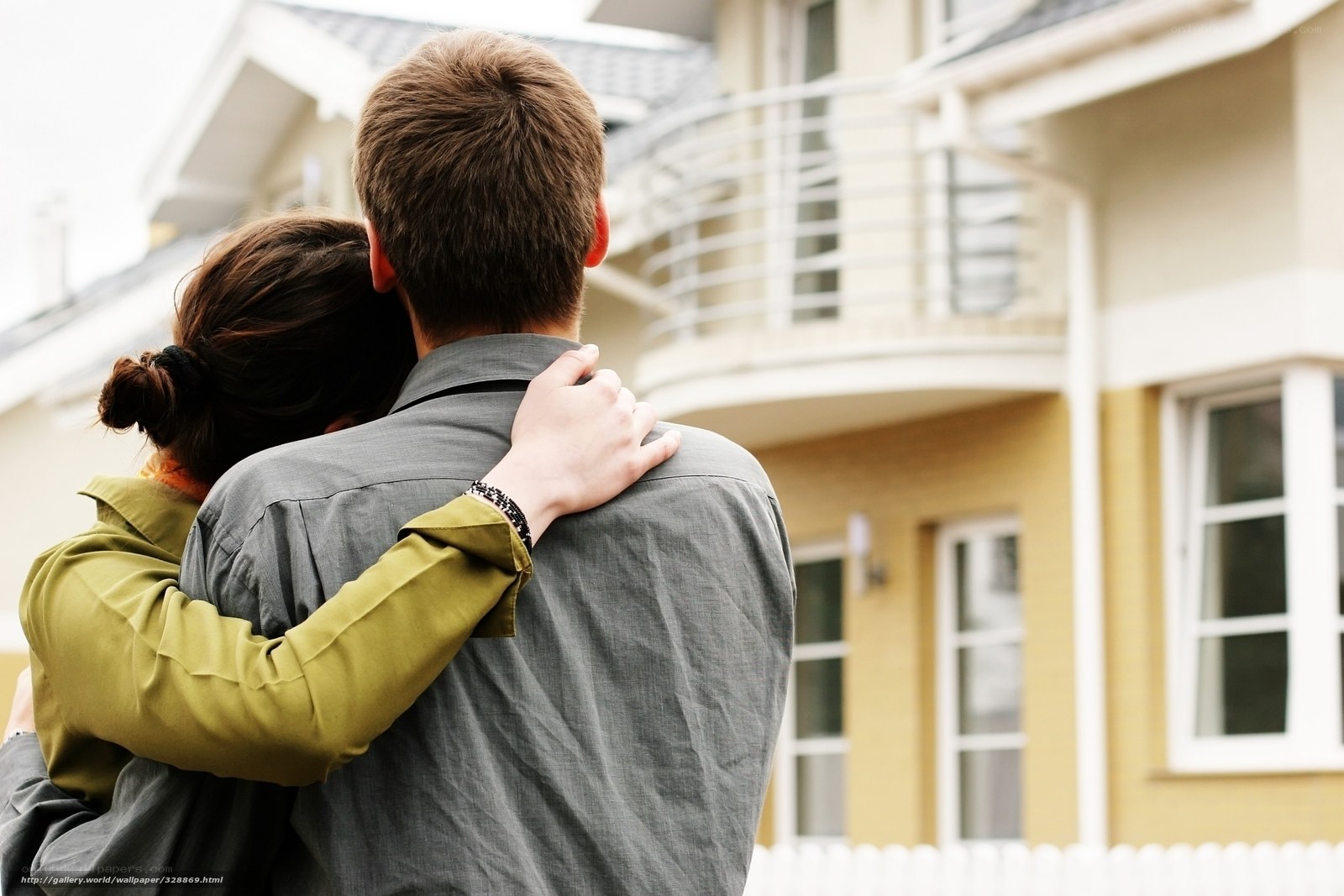 couple embracing by their home
